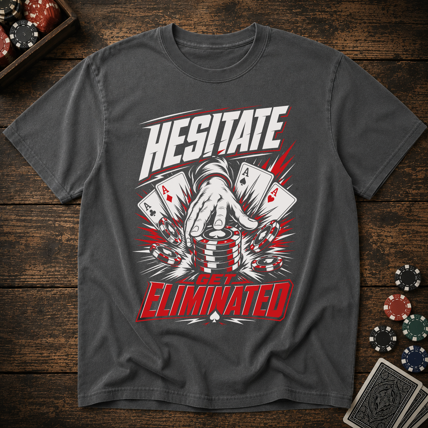 Gray t-shirt with poker-themed graphic and text on a wooden surface with playing cards and chips.